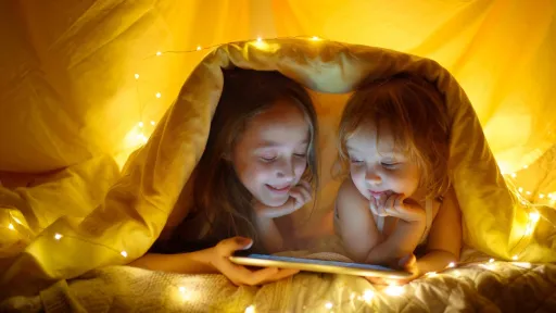 Two girls reading in a tent